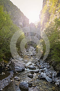 A deep gorge with a river in the mountains of Italy.