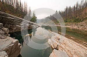 Deep Green Pool of still water in Meadow Creek Gorge in the Bob Marshall Wilderness area in Montana USA