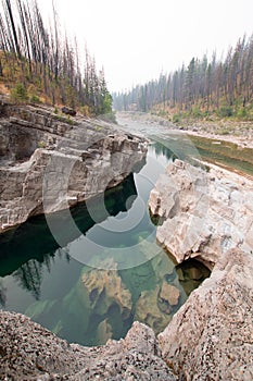 Deep Green Pool of still water in Meadow Creek Gorge in the Bob Marshall Wilderness area in Montana USA