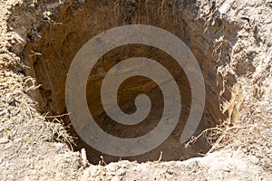 a deep hole is dug in the ground, a sinkhole in the ground
