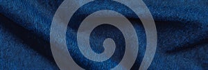 Deep indigo cotton fabric with chambray weave on bright background for design use photo