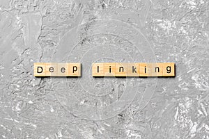 Deep Linking word written on wood block. Deep Linking text on cement table for your desing, concept
