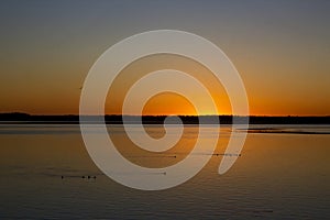 Deep Orange Sunset Over Netarts Bay With Birds Oregon