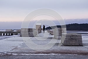 Deep perspective of a man on a pier in winter.