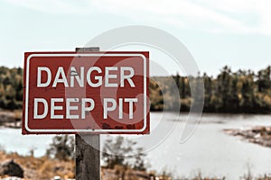Deep pit danger sign. Red sign