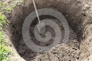 Deep pit in the ground. Digging a hole. photo
