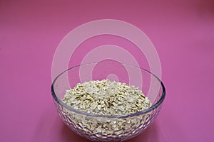 Deep plate with oatmeal inside on a lilac background