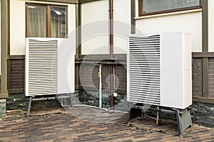 Deep radiators, heat pump, mounted near the house photo