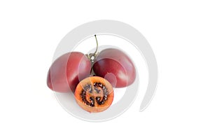 Deep red tamarillo tree tomato sliced and whole