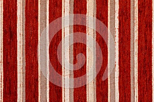 Red vertical striped synthetic woven upholstery fabric close-up texture and background
