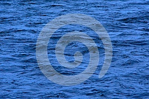 Deep blue rippling water surface background