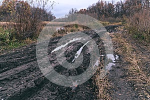 Deep ruts in the slushy autumn road