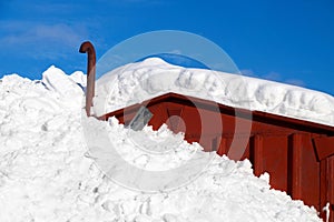 Deep snow covering half a house in countryside Norway, Europe