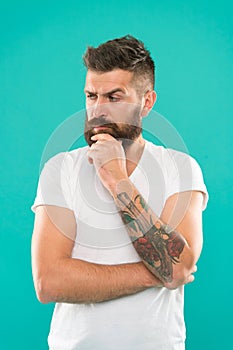 Deep thoughts. Man serious face not confident. Have some doubts. Hipster bearded face not sure in something. Doubtful