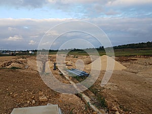 Deep trench cut in the dirt at construction site