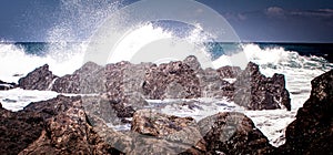 Deep view over lava rocks in the game of waves