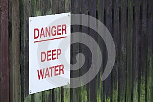 Deep water danger sign on sea wall