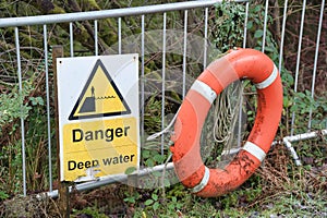 Deep water danger yellow symbol sign and red lifebuoy