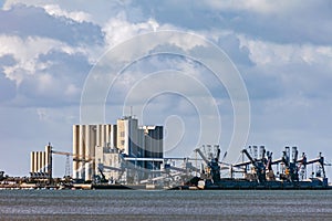 Deep water port for ships transporting grain with large silos and cranes in Trafaria photo