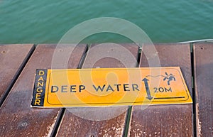 Deep water warning sign on lake side