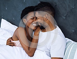 A deeper love is a different kind of connection. a young couple being intimate in bed at home.