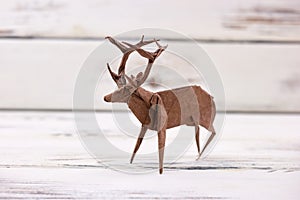 Deer figurine on wooden background