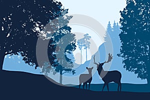 Deer and hind standing among trees in landscape with hill under