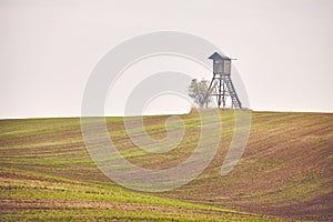 Deer hunting pulpit on a field in Autumn