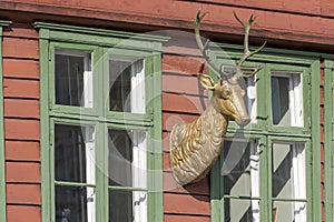 Deer sign on picturesque colorful facade at Briggen harbor waterfront, Bergen , Norway