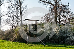 A deer stand in front of a meadow in the Natural Reserve schoenbuch in Germany