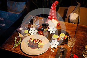 Deer tenderloin and dessert. Christmas table served for eve celebration event. Delicious healthy traditional food served