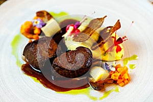 Deer tenderloin. Truffle-potato puree, porcini mushrooms, baked leek and carrot, juniper bread, port wine sauce