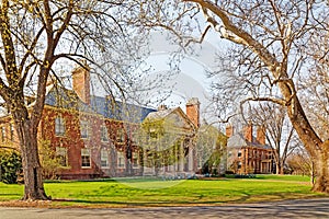 Deerfield Academy framed by two trees in Spring