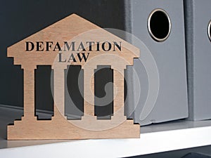 Defamation law plate on the shelf. photo