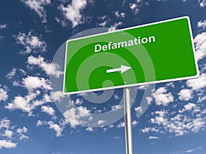 defamation traffic sign on blue sky photo