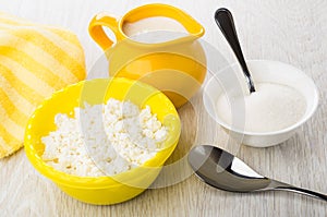 Defatted cottage cheese, napkin, jug with yogurt, bowl with sugar