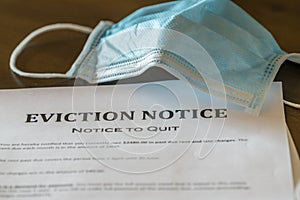 Official legal eviction order or notice to renter or tenant of home with face mask photo