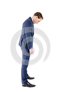 Defeated businessman looking at his shoes