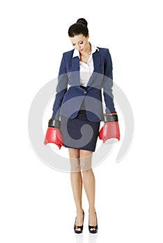 Defeated businesswoman in boxing gloves