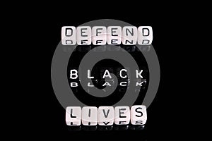 Defend black lives text on a black background. BLM in support of African Americans people