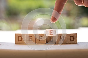 DEFEND DEFUND Police concept on wood blocks as finger points photo