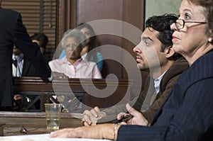 Defense Lawyer With Client In Court