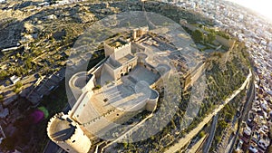 Defense Walls of Ancient fortress Alcazaba of Almeria, Spain - aerial shot including panoramic view of the Almeria city