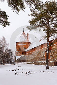 Defensive stone walls of historical Trakai castle covered with snow, Lithuania. Winter landscape