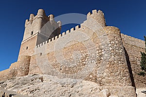 Defensive wall and stone towers of the medieval Atalaya Castle of Arab origin. Villena, Alicante, Spain