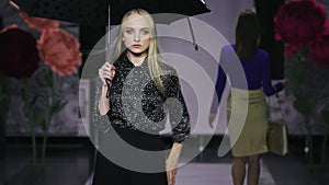 Defile beautiful women hold umbrella catwalk model show vogue. Girl podium 4k.