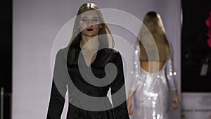 Defile pretty girl closeup long black dress on catwalk model show slow motion 4K