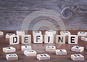 Define from wooden letters on wooden background