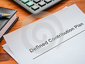 Defined contribution plan papers and a calculator.