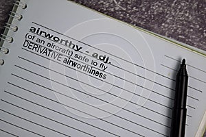 Definition of Airworthy word with a meaning on a book. dictionary concept photo